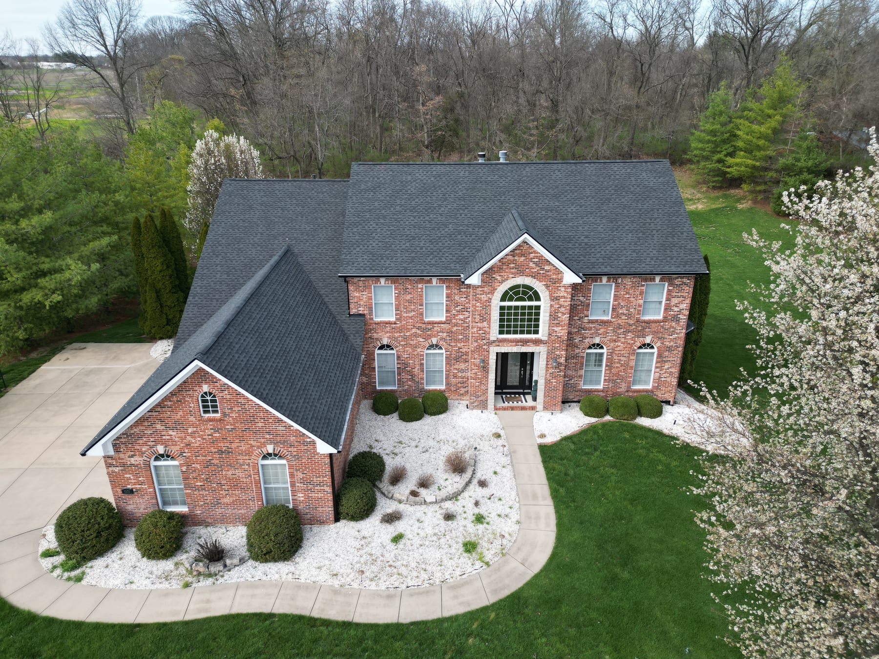 Completed architectural shingle roof on a brick two-story home in the Belleville, IL area