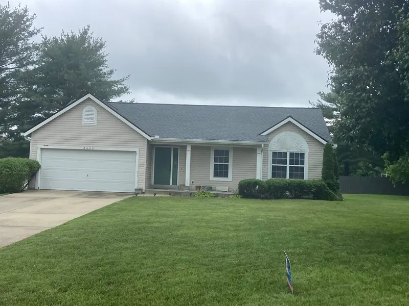 Finished shingle roof and white gutters on a tan ranch home in Columbia, IL