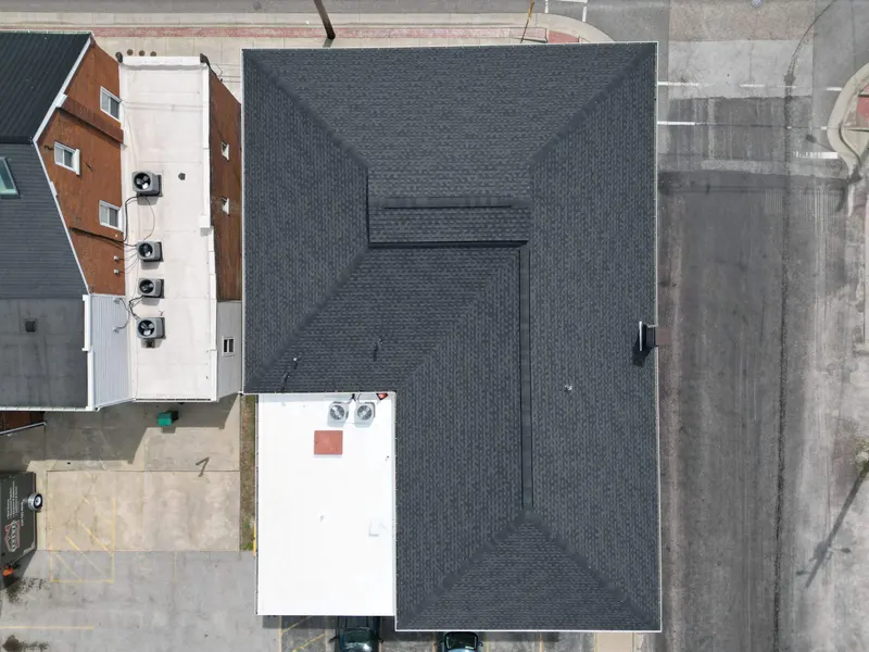Aerial view of a large shingle roof on a commercial building in Millstadt, IL