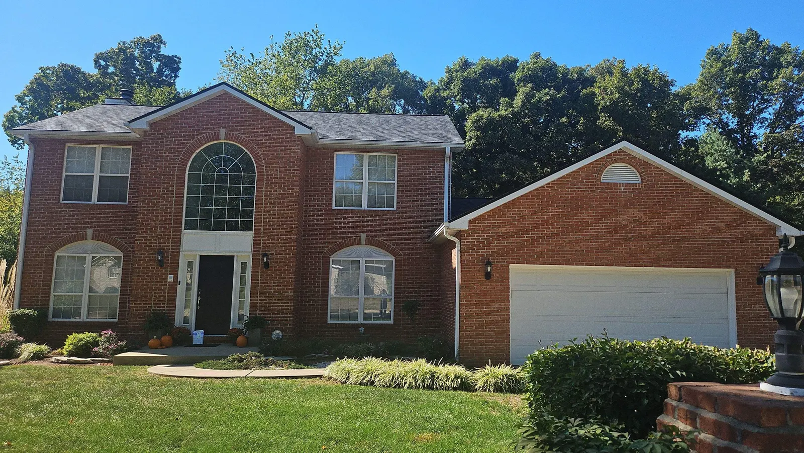Completed architectural shingle roof on a brick two-story home in Swansea, IL